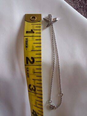 Silver “X” pendant adjustable bracelet with rhinestone detail